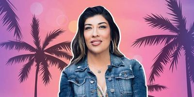 Photo of Lucy Flores smiling in front of palm trees.