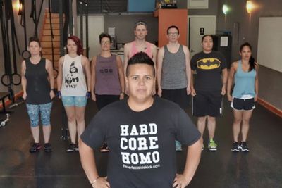 Coach Nathalie Huerta in a gym with seven people behind her inside a gym