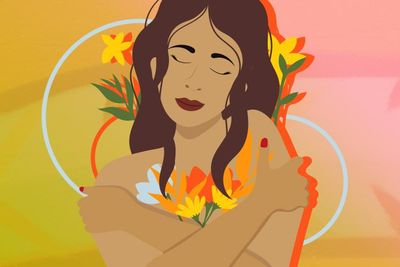woman hugging herself with flowers surrounding her 