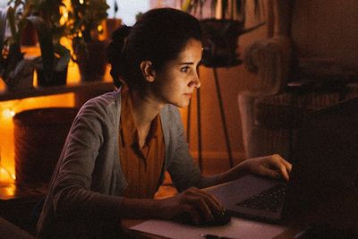woman at her laptop at night