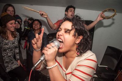victoria ruiz, singer, performing with others in the background