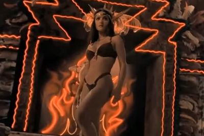 movie still from the film "From Dusk Til Dawn" starring Salma Hayek, showing Salma in a bikini with flames in the background