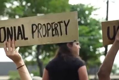 cardboard sign at a protest in puerto rico that reads "u.s. colonial property" 