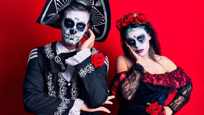 a man dresses up as a catrin and a woman is dressed up as a catrina