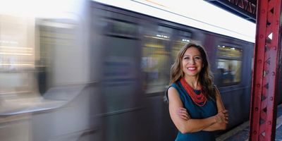 Latina woman, Jessica González-Rojas, standing in front of the subway