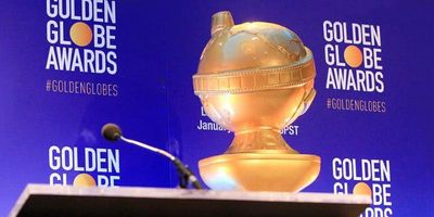 golden globe award in front of backdrop
