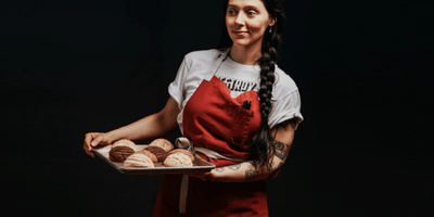 woman, Mariela Camacho, holding pastries
