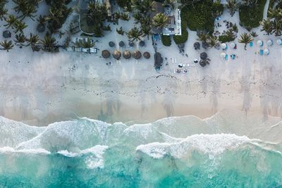 aerial photo of a Tulum, Mexico white sand beach and turquoise clear ocean water 