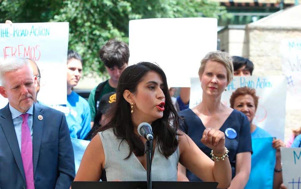 woman, New York State Senator Jessica Ramos, speaking at a microphone